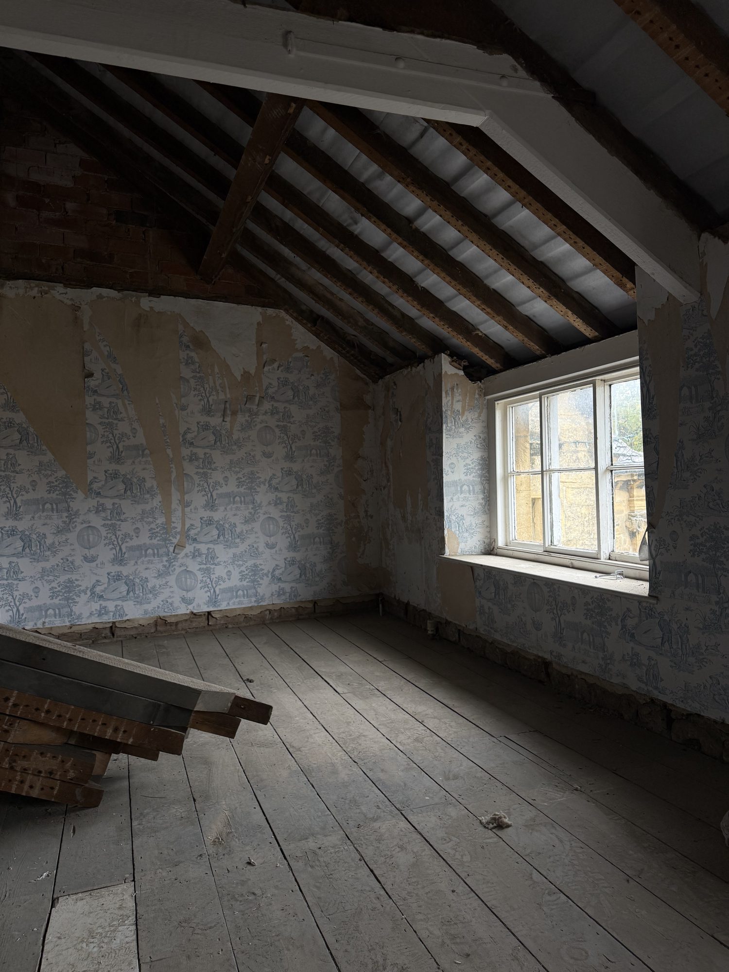 Sundial, as found: a top-floor room with old wallpaper