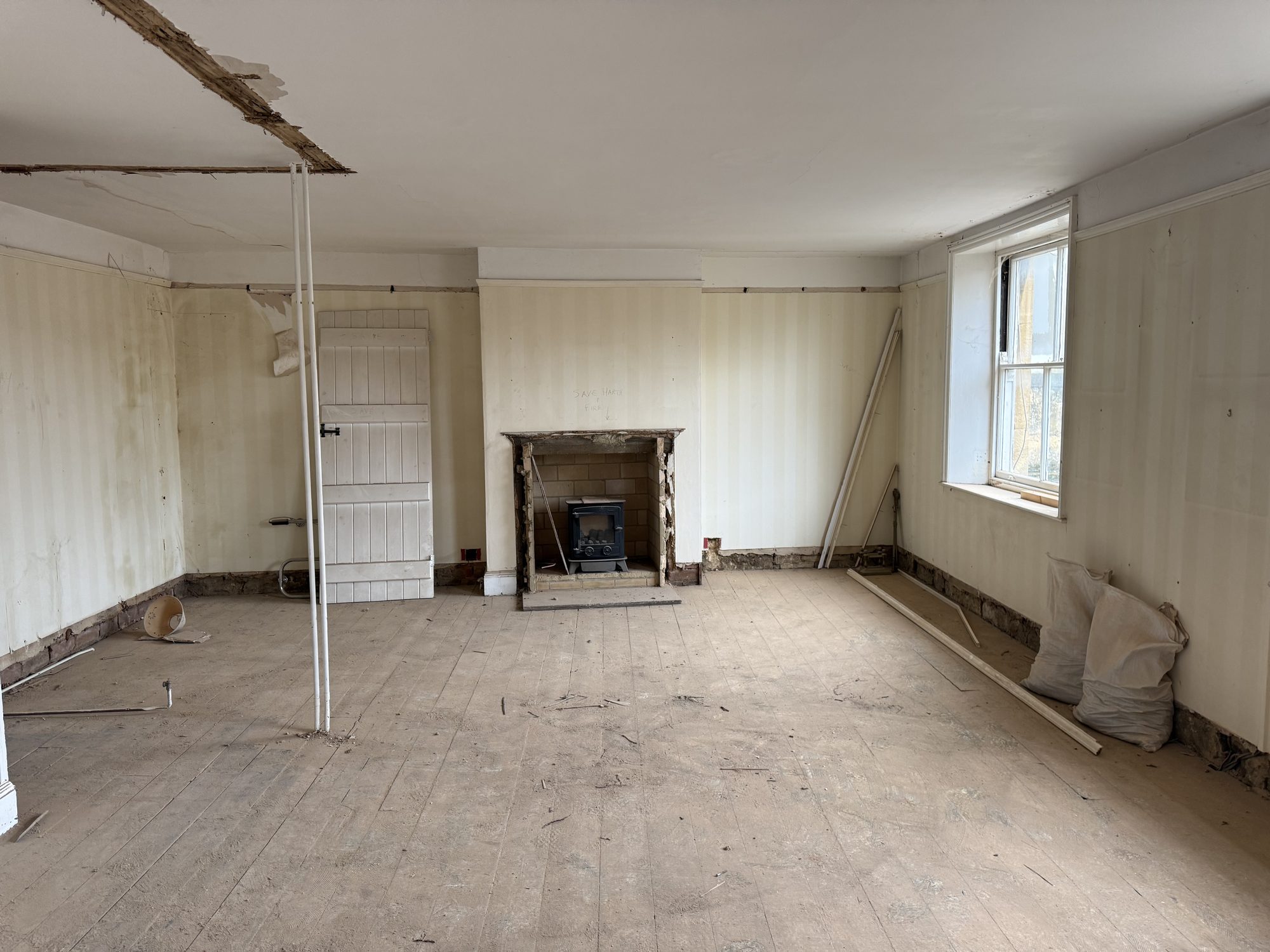 Sundial, as found: a panelled room with a fireplace