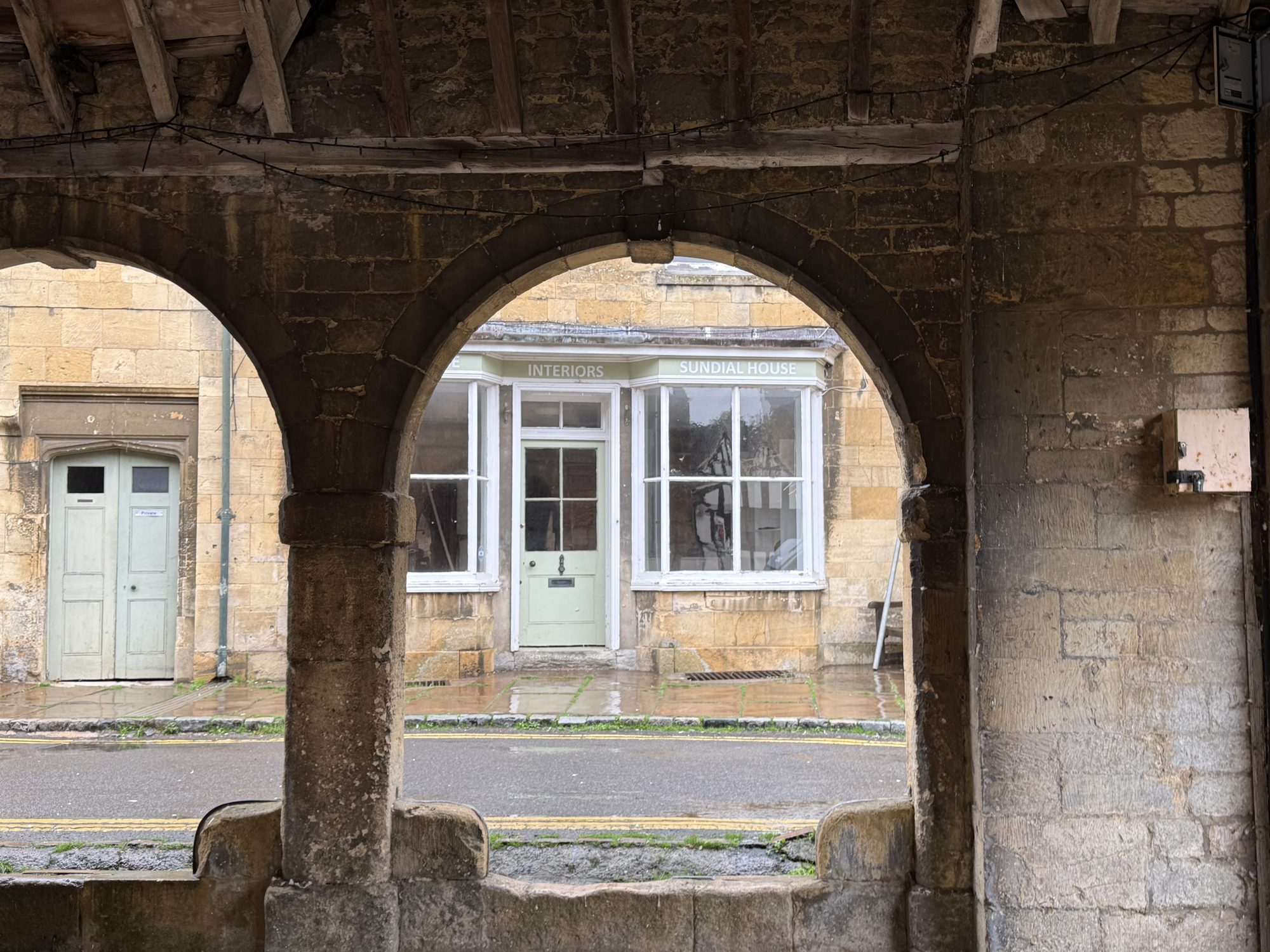 Sundial, the front of the house seen through the Market Hall arches