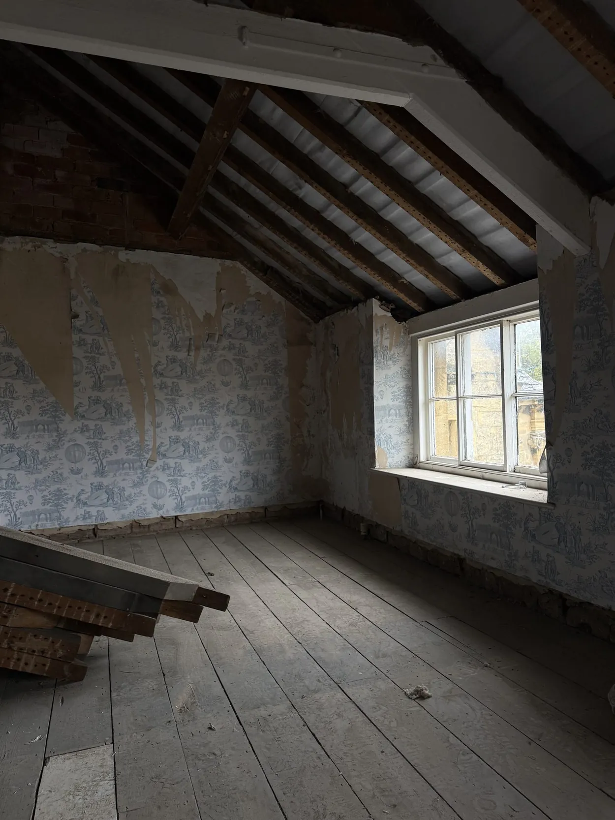 Sundial, as found: a top-floor room with old wallpaper