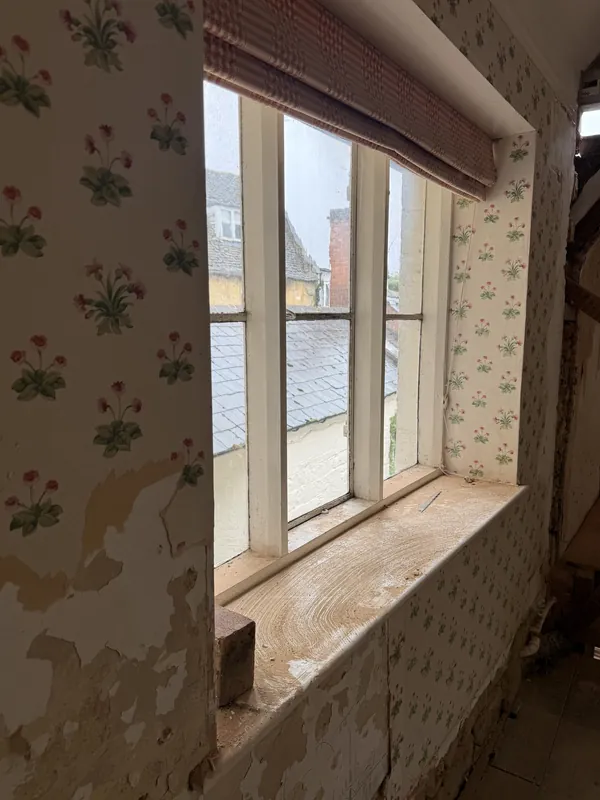 Sundial, floral wallpaper in a window reveal