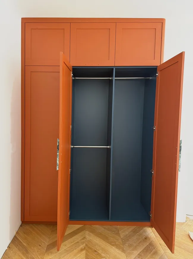 A Walk in the Park, the second bedroom wardrobe open, with its deep blue internals