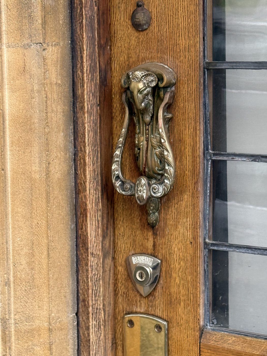 Sundial, a brass knocker on an oak door