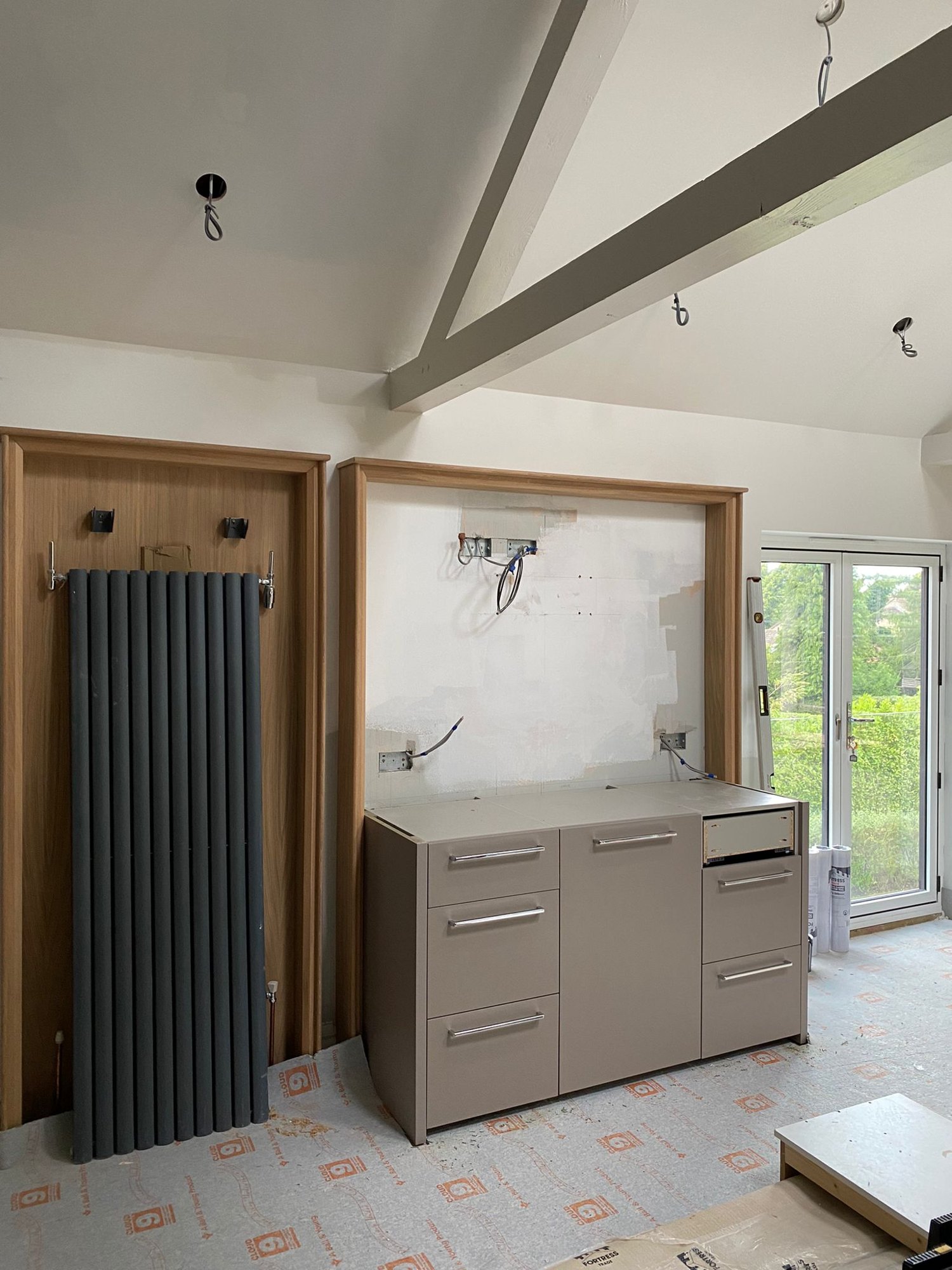 Suite Escape, The coffee station going in, framed in oak, with the radiator on its own oak panel
