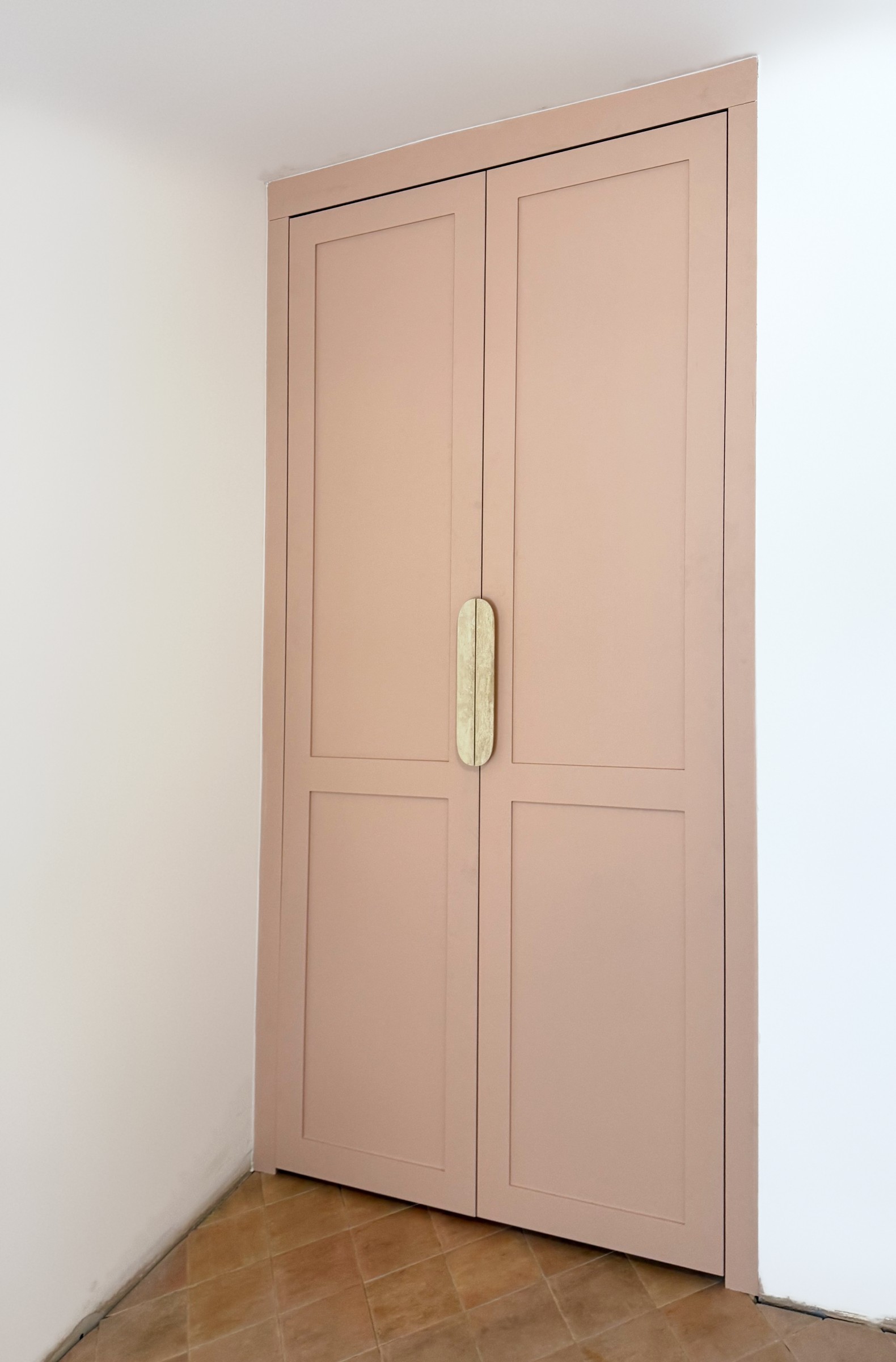 A Walk in the Park, the studio wardrobe, hand-painted in a soft, dusty pink, with a travertine handle