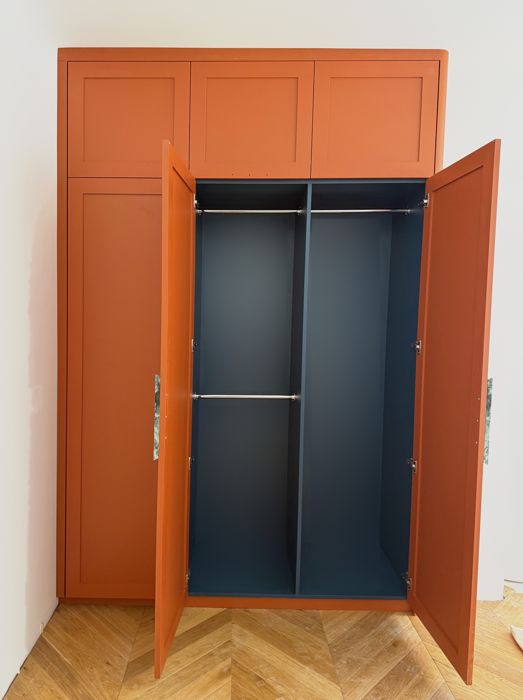 A Walk in the Park, the second bedroom wardrobe open, with its deep blue internals